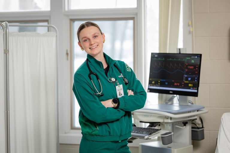 UND nursing student stands in a clinic room