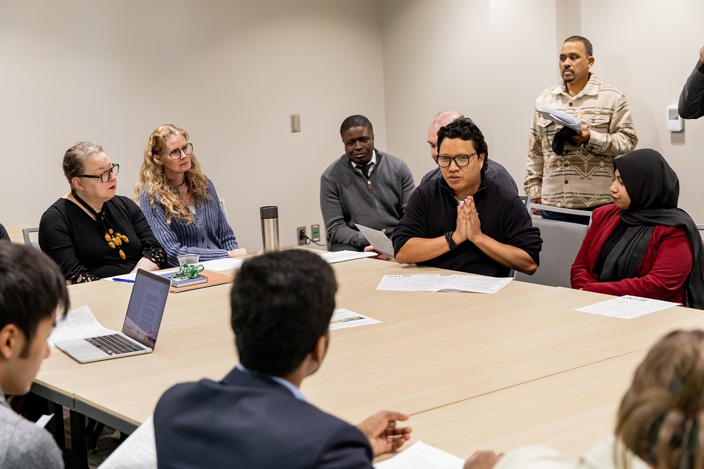 Conferees sitting around a conference table