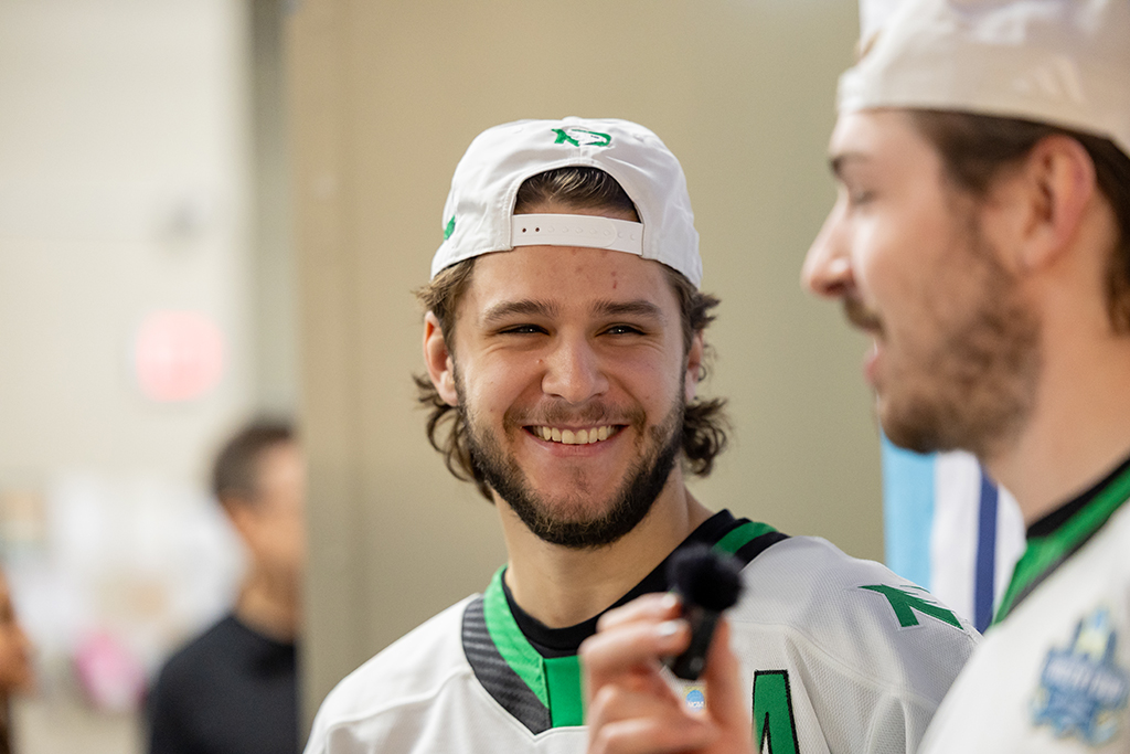 Player wearing backwards hat, smiling during interview
