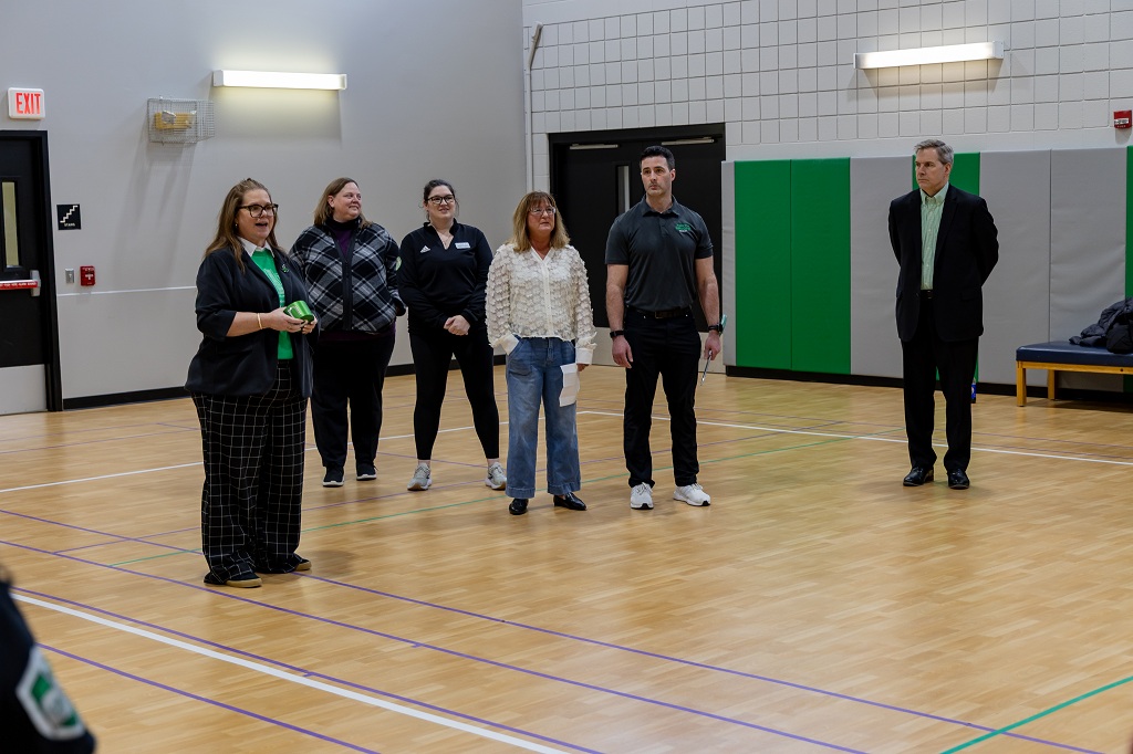 Men and women standing in a gymnasium