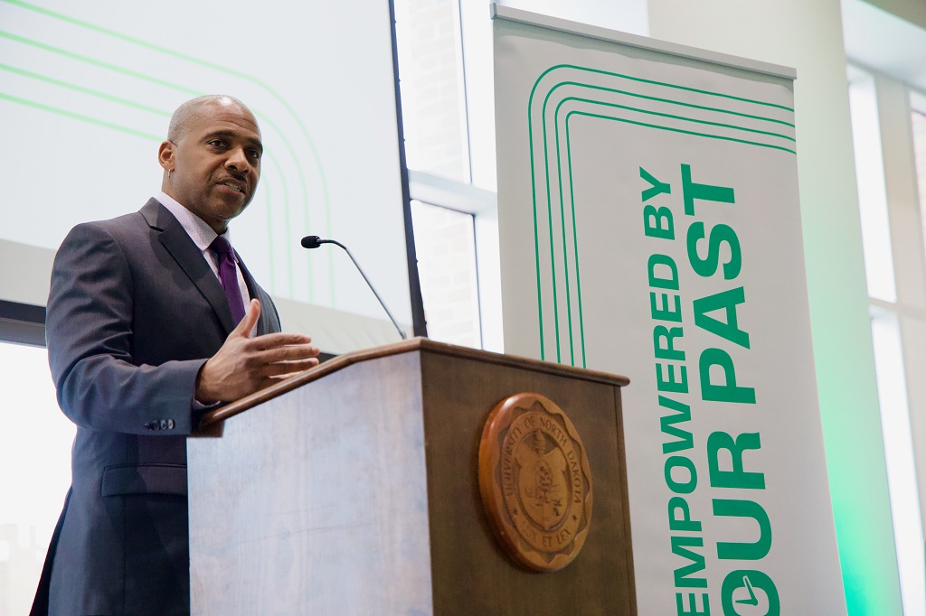Man standing at podium delivering remarks