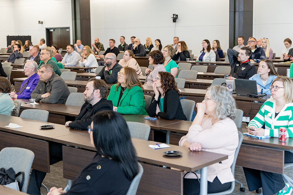 many people sitting in a lecture-style room