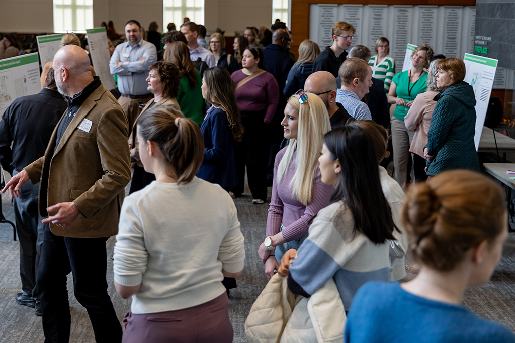 people crow around posters and offer feedbacck on the data displayed on them