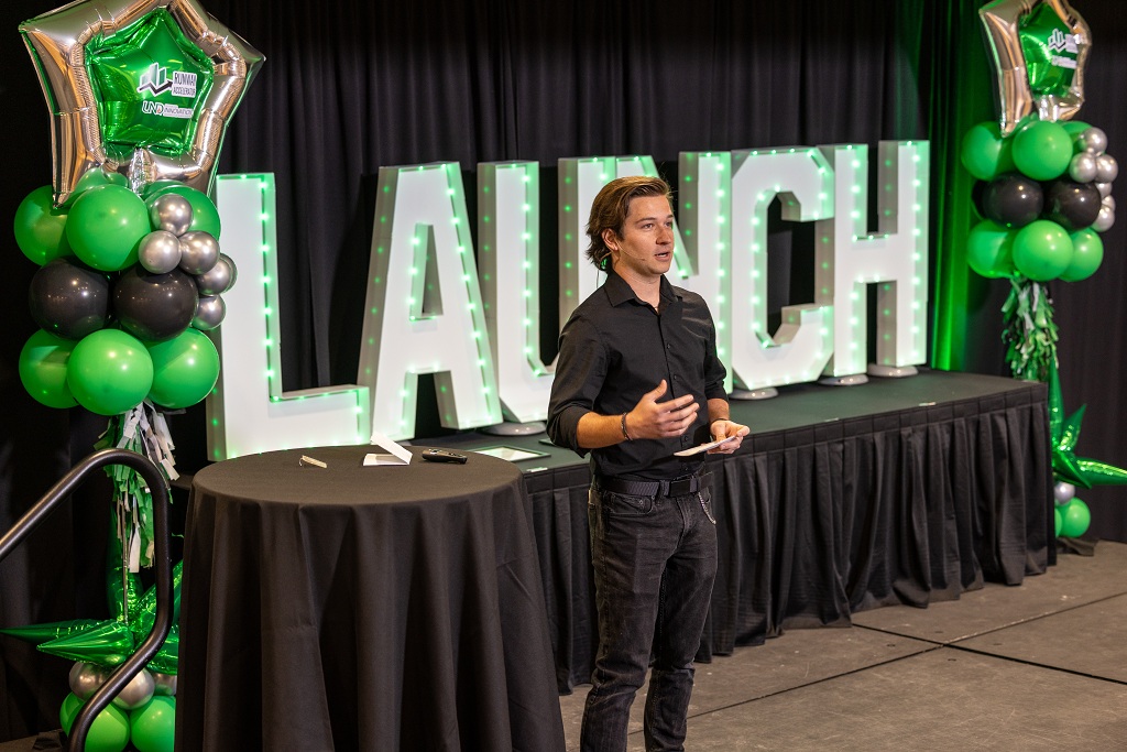 Spencer Milanowski on stage at LAUNCH event
