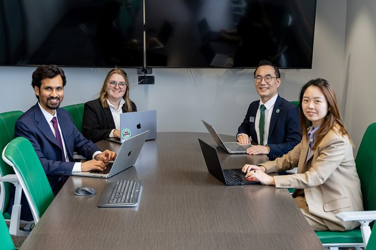 4people sitting around a conference table