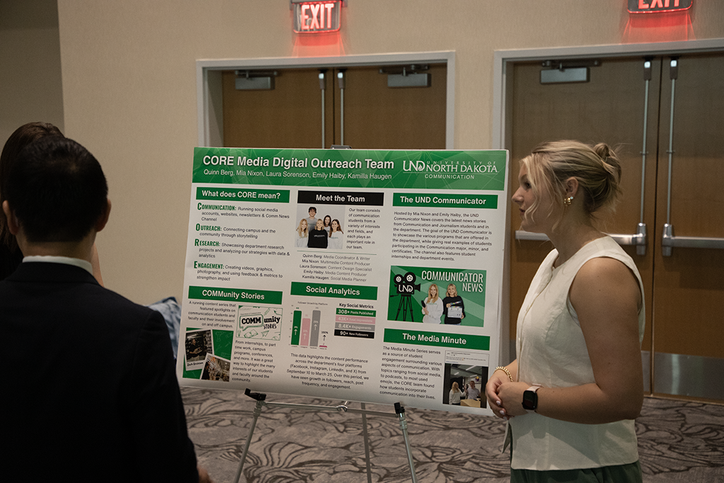 woman presenting poster