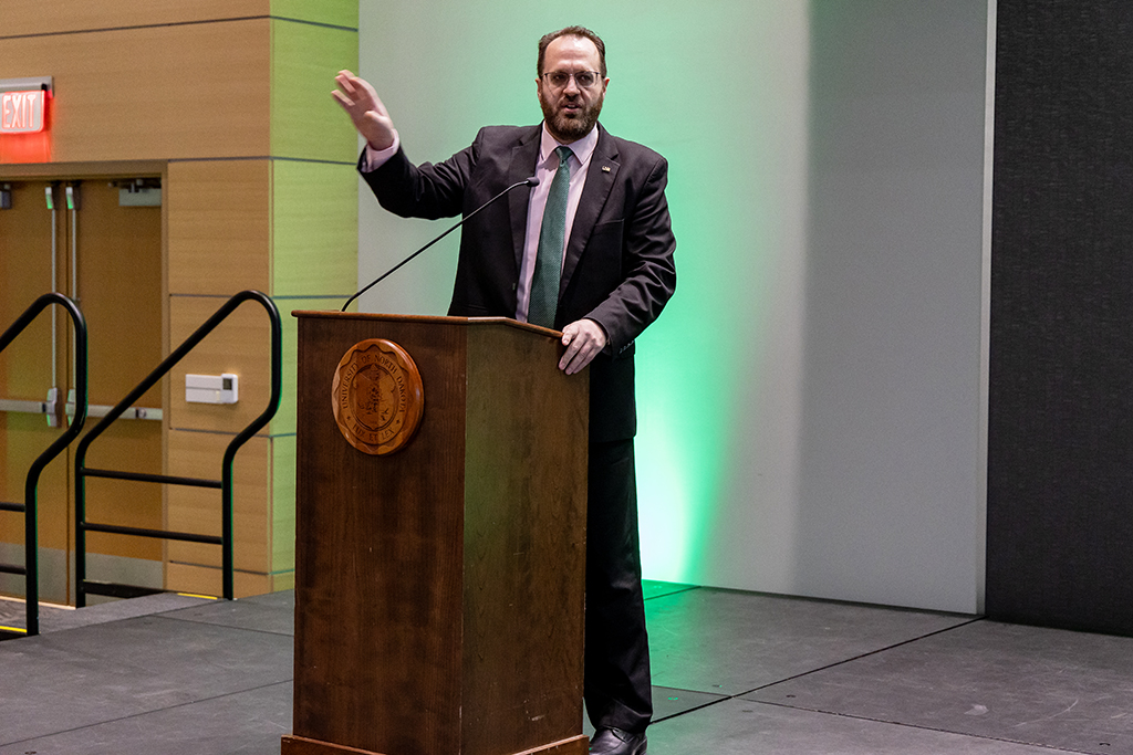 man speaking at podium