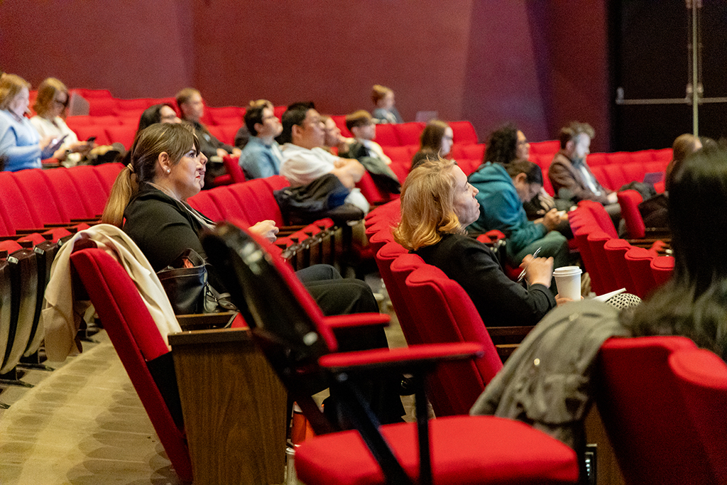 people sitting in a thearer for a talk