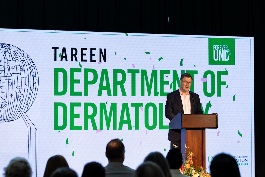 President Armacost speaks at podium of press conference