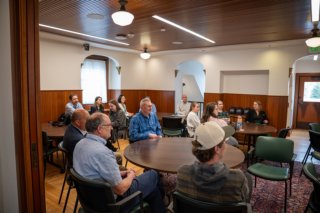Photo of people sitting in a room at an event.