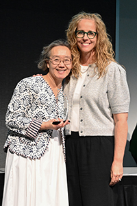 Yee Han Chu stands with Karla Mongeon-Stewart, accepting her meritorious service award