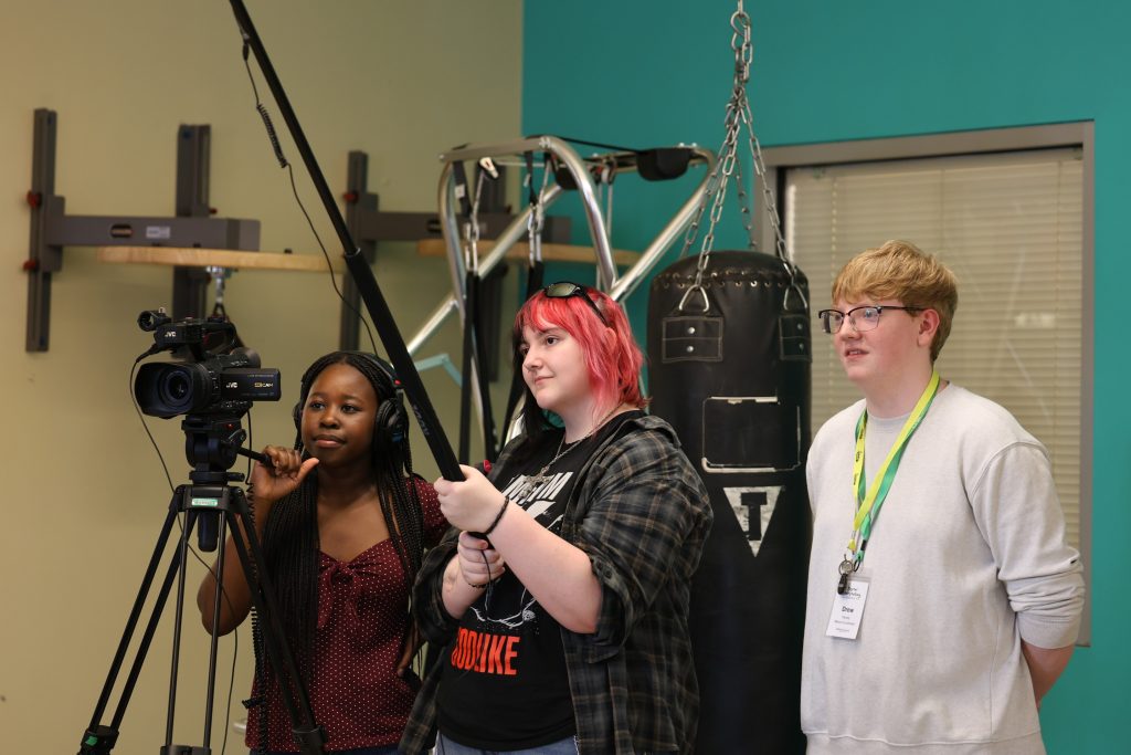 Students operate video production equipment during the Digital Storytelling Summit.