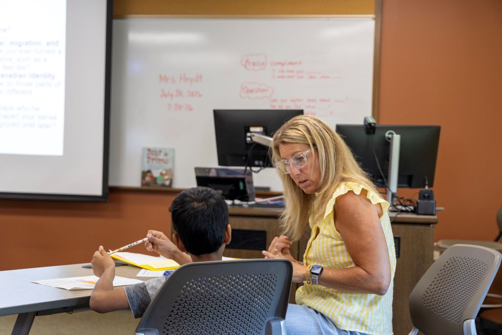 Mrs. Heydt helps a student in class