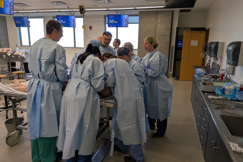 Area surgeons at UND gather around an operating table for training