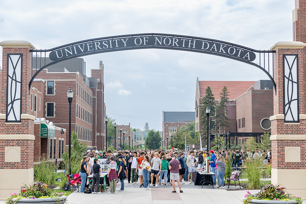 Students gathered for organization fair under University of North Dakota archway