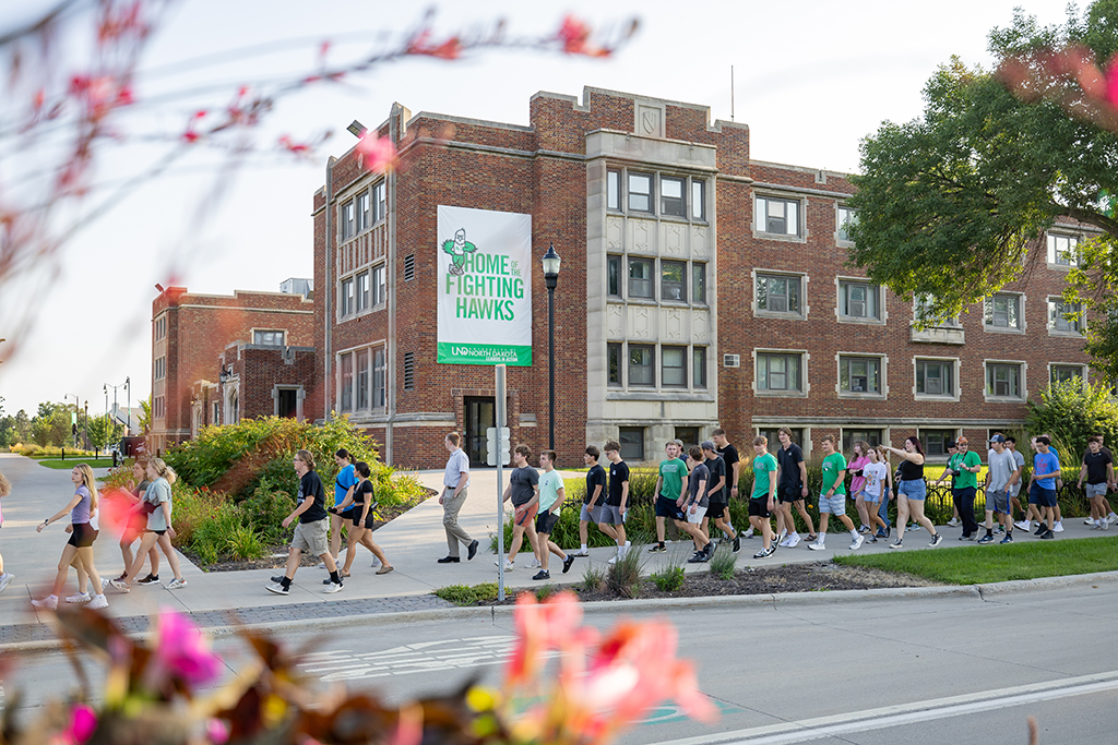 Students walking along University Avenue with Johnstone Hall in background