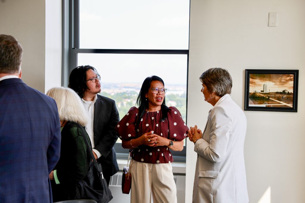 Attendees talk amongst themselves at a reception.