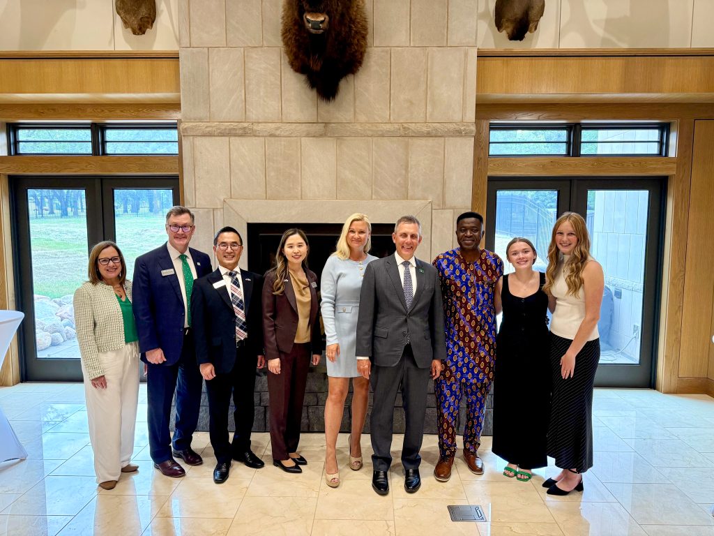Nine people gather to take a picture at Governor Burgum's residence.