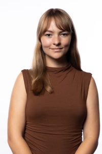 Portrait of Sophia Fafard wearing a brown top against a white background.